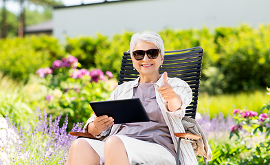 Image showing happy senior woman with tablet pc at summer garden