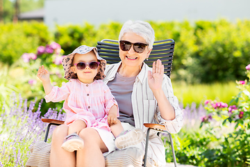 Image showing happy grandmother and baby granddaughter at garden