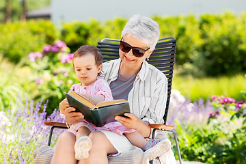 Image showing grandmother and baby granddaughter reading book