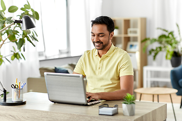 Image showing indian man with laptop working at home office