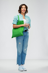 Image showing woman with bag for food shopping and glass bottle