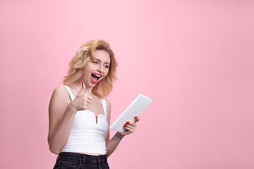 Image showing Caucasian young woman\'s portrait isolated on pink studio background. Beautiful female model. Concept of human emotions, facial expression, sales, ad, youth culture.