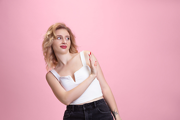 Image showing Caucasian young woman\'s portrait isolated on pink studio background. Beautiful female model. Concept of human emotions, facial expression, sales, ad, youth culture.