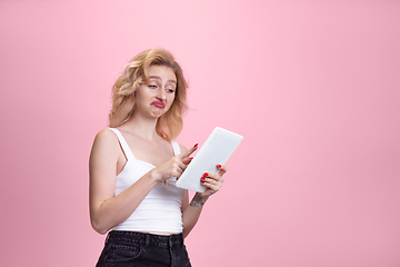 Image showing Caucasian young woman\'s portrait isolated on pink studio background. Beautiful female model. Concept of human emotions, facial expression, sales, ad, youth culture.