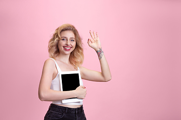 Image showing Caucasian young woman\'s portrait isolated on pink studio background. Beautiful female model. Concept of human emotions, facial expression, sales, ad, youth culture.