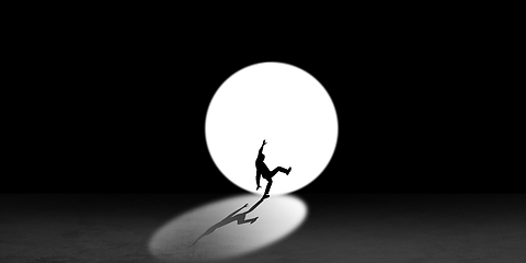 Image showing Silhouette of man walking in the night toward the light, view from above