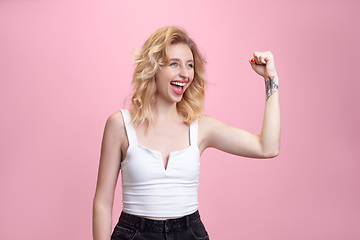 Image showing Caucasian young woman\'s portrait isolated on pink studio background. Beautiful female model. Concept of human emotions, facial expression, sales, ad, youth culture.