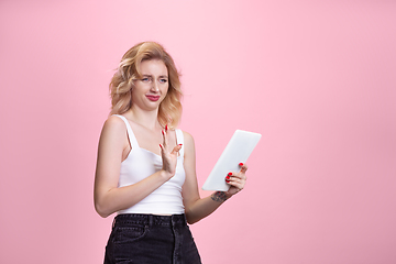 Image showing Caucasian young woman\'s portrait isolated on pink studio background. Beautiful female model. Concept of human emotions, facial expression, sales, ad, youth culture.