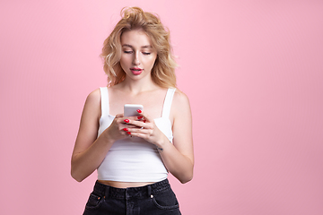 Image showing Caucasian young woman\'s portrait isolated on pink studio background. Beautiful female model. Concept of human emotions, facial expression, sales, ad, youth culture.