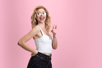 Image showing Caucasian young woman\'s portrait isolated on pink studio background. Beautiful female model. Concept of human emotions, facial expression, sales, ad, youth culture.