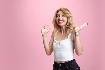 Image showing Caucasian young woman\'s portrait isolated on pink studio background. Beautiful female model. Concept of human emotions, facial expression, sales, ad, youth culture.