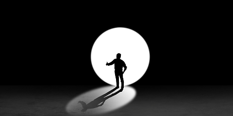 Image showing Silhouette of man walking in the night toward the light, view from above
