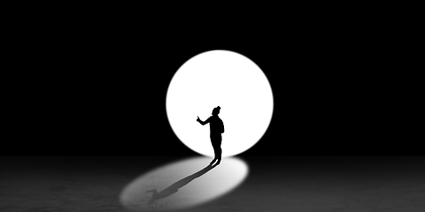 Image showing Silhouette of man walking in the night toward the light, view from above