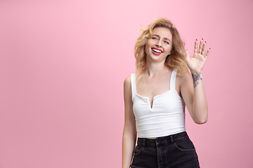 Image showing Caucasian young woman\'s portrait isolated on pink studio background. Beautiful female model. Concept of human emotions, facial expression, sales, ad, youth culture.