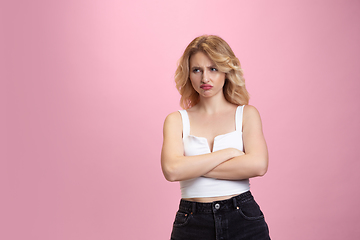 Image showing Caucasian young woman\'s portrait isolated on pink studio background. Beautiful female model. Concept of human emotions, facial expression, sales, ad, youth culture.