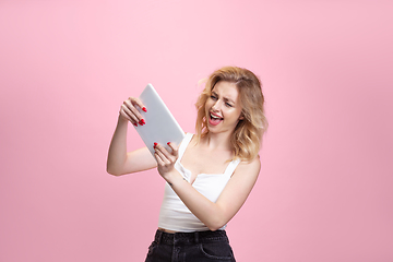 Image showing Caucasian young woman\'s portrait isolated on pink studio background. Beautiful female model. Concept of human emotions, facial expression, sales, ad, youth culture.