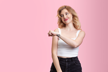 Image showing Caucasian young woman\'s portrait isolated on pink studio background. Beautiful female model. Concept of human emotions, facial expression, sales, ad, youth culture.