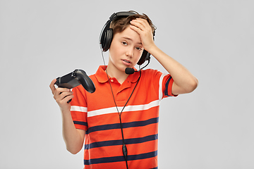 Image showing boy in headphones with gamepad playing video game