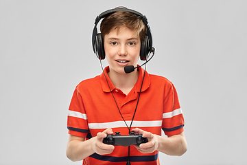 Image showing boy in headphones with gamepad playing video game