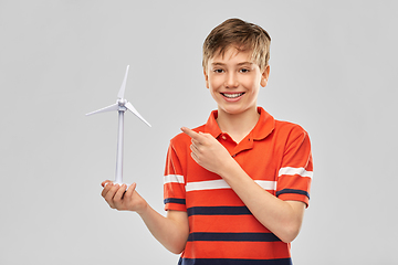 Image showing happy smiling boy holding toy wind turbine