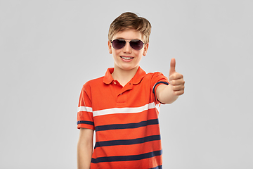 Image showing smiling boy in sunglasses showing thumbs up