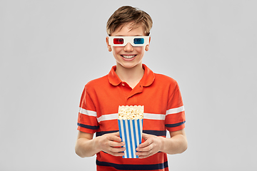 Image showing smiling boy in 3d movie glasses eating popcorn