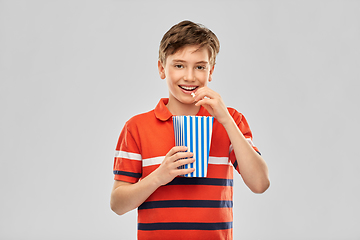 Image showing smiling boy eating popcorn