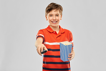 Image showing smiling boy with popcorn and tv remote control