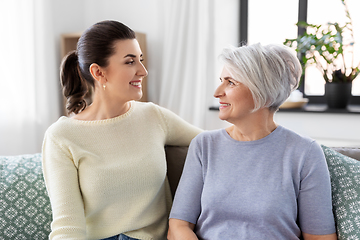 Image showing senior mother with adult daughter talking at home