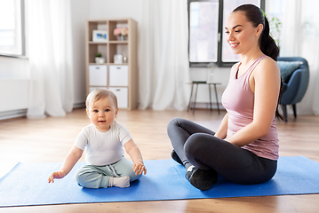 Image showing happy mother with little baby at home