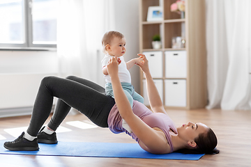 Image showing mother with little baby exercising at home