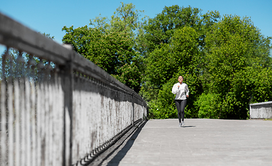 Image showing african american woman running outdoors