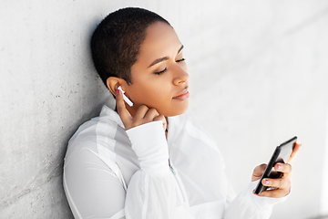 Image showing african american woman with earphones and phone