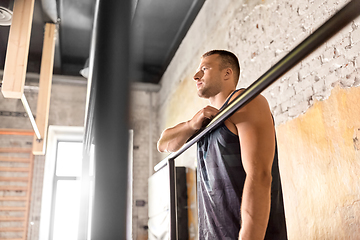 Image showing young man at parallel bars in gym