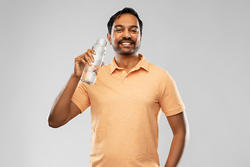 Image showing happy indian man drinking water from glass bottle