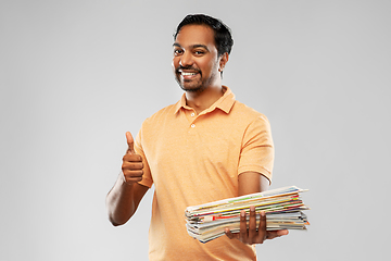 Image showing indian man with paper waste showing thumbs up