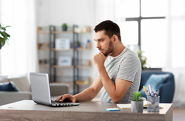 Image showing man with laptop working at home office