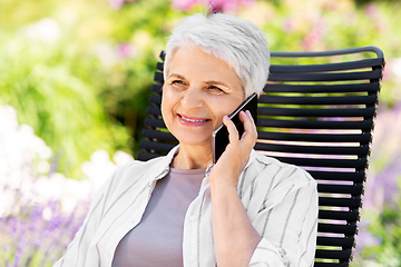 Image showing happy senior woman calling on phone at garden