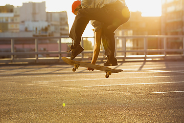 Image showing Skateboarder doing a trick at the city\'s street in summer\'s sunshine