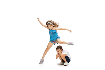 Image showing Happy little caucasian girl and boy jumping and running isolated on white background