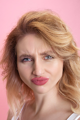 Image showing Caucasian young woman\'s portrait isolated on pink studio background. Beautiful female model. Concept of human emotions, facial expression, sales, ad, youth culture.