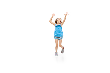 Image showing Happy little caucasian girl jumping and running isolated on white background