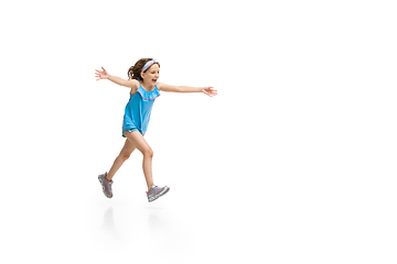 Image showing Happy little caucasian girl jumping and running isolated on white background