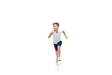 Image showing Happy little caucasian boy jumping and running isolated on white background