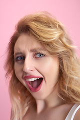 Image showing Caucasian young woman\'s portrait isolated on pink studio background. Beautiful female model. Concept of human emotions, facial expression, sales, ad, youth culture.