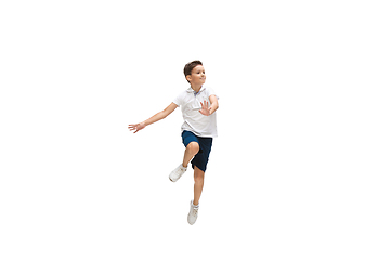 Image showing Happy little caucasian boy jumping and running isolated on white background