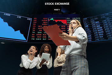 Image showing Nervous tensioned investors analyzing crisis stock market with charts on screen on background, falling stock exchange