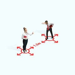 Image showing Studio shot of people demonstrating social distancing with arrows indicating the separation.