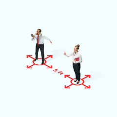 Image showing Studio shot of people demonstrating social distancing with arrows indicating the separation.