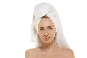 Image showing Beauty Day. Woman wearing towel doing her daily skincare routine. Portrait isolated on white studio background